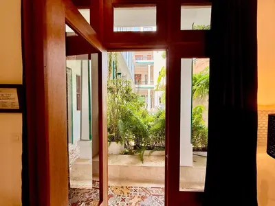 an open door with a view of a courtyard at Boutique Hotel Casa Grande, Mango Tango Suite in Santo Domingo