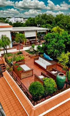 an overhead view of a patio with benches and trees at Luxury Two-Level Townhouse with Stunning Historic Views in Santo Domingo