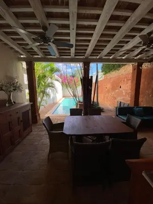 a patio with a table and chairs and a pool at Luxury Two-Level Townhouse with Stunning Historic Views in Santo Domingo