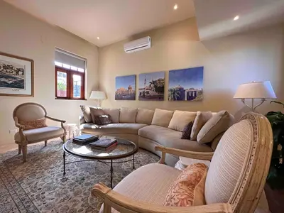 a living room with a couch and a table at Luxury Two-Level Townhouse with Stunning Historic Views in Santo Domingo