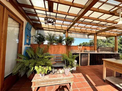 an outdoor patio with a table and potted plants at Luxury Two-Level Townhouse with Stunning Historic Views in Santo Domingo