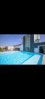 a large blue swimming pool in front of a building at Luxury Apartment in Santo Domingo
