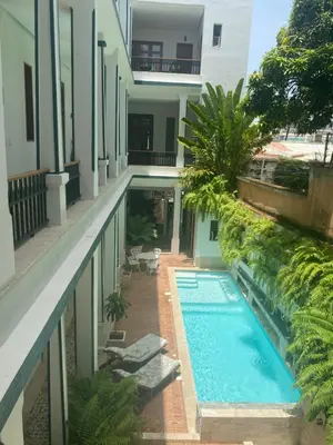 a swimming pool in the middle of a building at Boutique Hotel Casa Grande, Tropical Journey, Suite familiar de 2 dormitorios in Santo Domingo