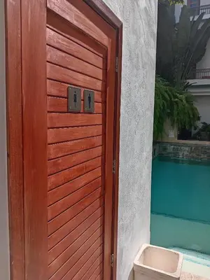 a wooden door to a house with a pool at Boutique Hotel Casa Grande, Tropical Journey, Suite familiar de 2 dormitorios in Santo Domingo