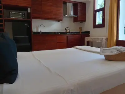 a kitchen with a large white bed in a room at Boutique Hotel Casa Grande, Chocolate Paradise, Estudio superior con Cocina in Santo Domingo