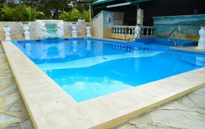 a large swimming pool with blue water at Villas Jazmin in San Felipe de Puerto Plata