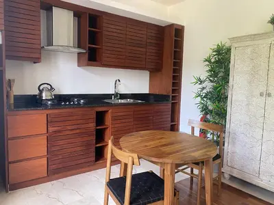 a kitchen with a wooden table and a sink at Boutique Hotel Casa Grande, Divas Suite in Santo Domingo