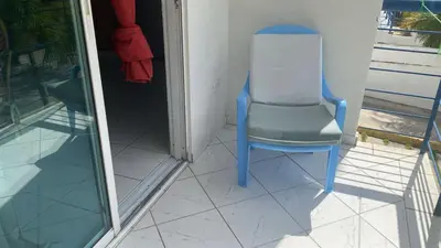 a blue chair sitting on a porch at Edificio maremma 6 in Boca Chica