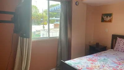 a bedroom with a bed and a window at Edificio maremma 6 in Boca Chica