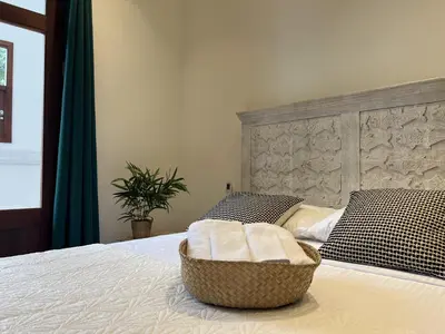 a bedroom with a bed with a basket on it at Boutique Hotel Casa Grande, Dominican Voyage, Suite familiar de 2 dormitorios in Santo Domingo