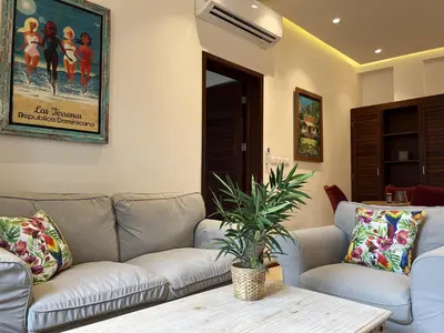 a living room with a couch and a table at Boutique Hotel Casa Grande, Dominican Voyage, Suite familiar de 2 dormitorios in Santo Domingo