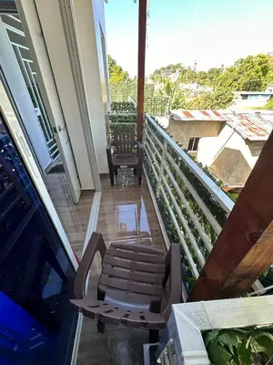 a balcony with a pair of chairs and a table at Two levels Las Terrenas near to beaches in Las Terrenas