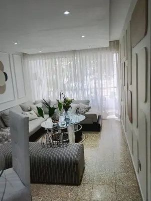 a living room with a couch and a table at Comfortable apartment in Santo Domingo