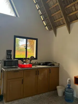 a kitchen with a counter top with a window at Charming Bungalow with Pool in Sosúa