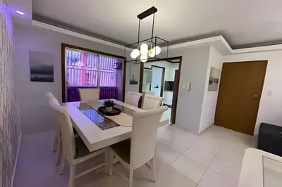 a dining room with a white table and chairs at Sunshine Palmares de Caleta in La Romana