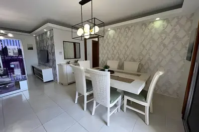 a dining room with a white table and chairs at Sunshine Palmares de Caleta in La Romana