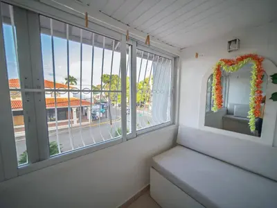 a room with a window with a bench and a view at Central 1BR APT - 1 minute Walking from Rumba in Sosúa
