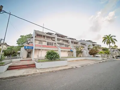 a building on the side of a street at Central 1BR APT - 1 minute Walking from Rumba in Sosúa