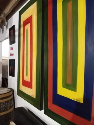 a group of colorful paintings on a wall at Chalet Thevenin Art Accommodation in Jarabacoa