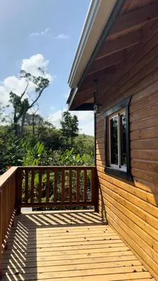 a wooden deck on the side of a house at Villas Gabriel in Nagua