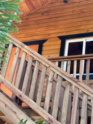 a wooden staircase in front of a log cabin at Villas Gabriel in Nagua