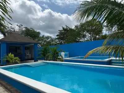 a blue swimming pool in front of a blue wall at Apartamento Costero 1 en Las Galeras in Las Galeras