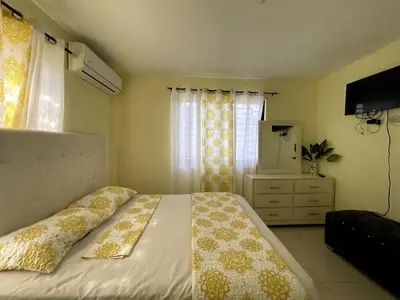 a bedroom with a bed and a dresser and a window at Apartamento Costero 1 en Las Galeras in Las Galeras