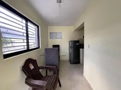 a living room with two chairs and a refrigerator at Apartamento Costero 1 en Las Galeras in Las Galeras
