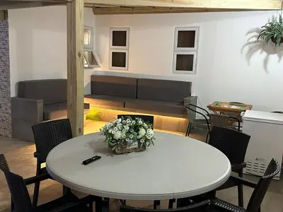 a white table with a basket of flowers on it at mamajuana House in Las Terrenas