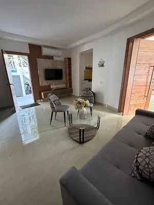 a living room with a couch and chairs and a table at mamajuana House in Las Terrenas