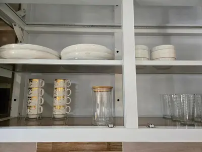 a cabinet with plates and bowls on a shelf at Casa Madome in Pedernales