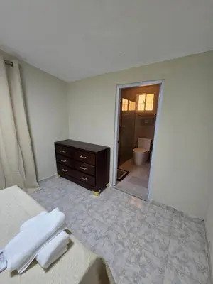a bedroom with a bed and a dresser and a bathroom at Casa Madome in Pedernales