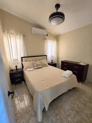 a bedroom with a large bed and two night stands at Casa Madome in Pedernales