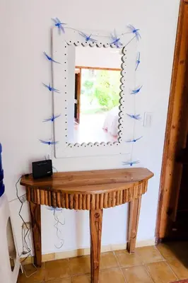 a mirror in a room with a wooden table at Lovely Beach Apartment in Tranquil Playa Bonita in Las Terrenas