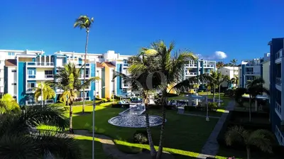 a view of a park with palm trees and buildings at Eden Caribe Condo, Bavaro Punta Cana in Punta Cana