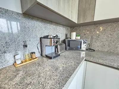 a kitchen with a counter top with a microwave at Luxury Apt with Pool Golf View in Hard Rock Golf in Punta Cana