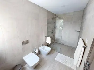 a bathroom with a toilet and a shower and a sink at Luxury Apt with Pool Golf View in Hard Rock Golf in Punta Cana