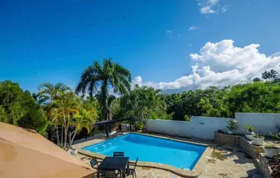a swimming pool in the backyard of a house at Villa with Oceanviews for All Types of Travelers in San Felipe de Puerto Plata