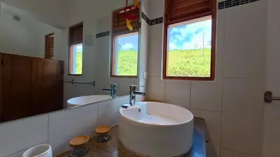 a bathroom with two sinks and a large mirror at The Nest, a quiet refuge with impressive views in Las Terrenas