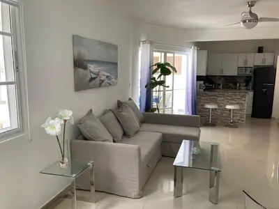 a living room with a couch and two tables at Luxury Beach flat in Bávaro Puntacana! in Punta Cana