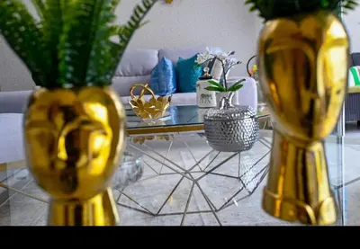two yellow vases with plants on a table in a living room at Modern Colonial Water View in Calero