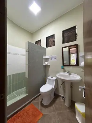 a bathroom with a toilet and a sink and a shower at CASA Angelo in Sosúa