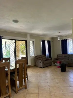 a living room with couches and a table and chairs at CASA Angelo in Sosúa