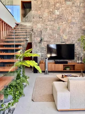a living room with a couch and a tv at Villa Barbara, serviced accommodation in the heart of Puntarena beach club in Sabana Buey