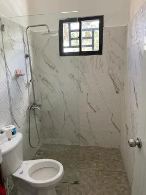 a bathroom with a shower with a toilet and a window at Villakeyden1 in Colorado