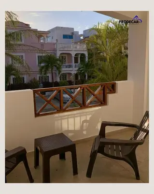 a balcony with two chairs and a bench on a balcony at apartment for rent in Bayahibe