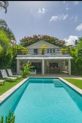 a villa with a swimming pool in front of a house at Canela House 3BR Near to the beach in Las Terrenas