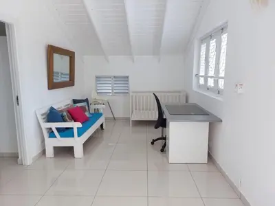 a room with a desk and a chair and a table at Canela House 3BR Near to the beach in Las Terrenas