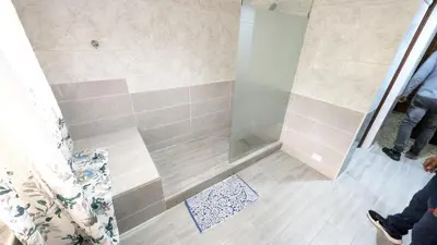 a shower with a glass door in a bathroom at Cofresi Villas in Maggiolo
