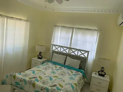 a bedroom with a bed and two night stands at Lunamare Residence in Los Grini